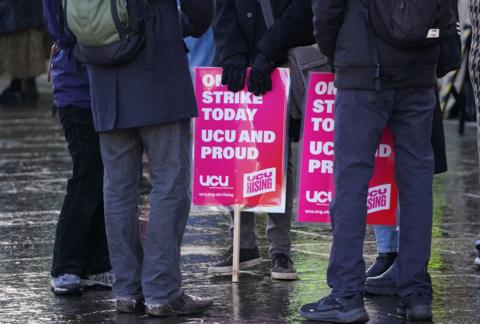 People holding UCU strike placards outside the Scottish parliament in 2023