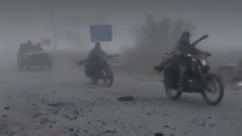 A foggy image of Russians on motor bike riding along a road in eastern Ukraine
