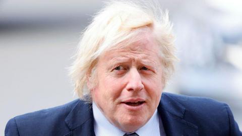 Close up of Boris Johnson in dark blue jacket with white striped shirt