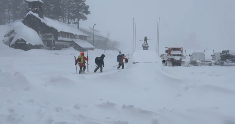 Skiers in the snow preparing for a rescue