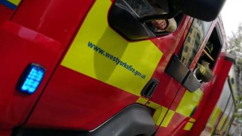 A close-up of a West Yorkshire Fire and Rescue Service vehicle. 