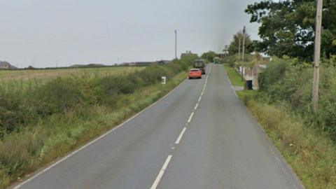 Street View of Cook's Lane - a long straight road with farm fields and a small hedge either side