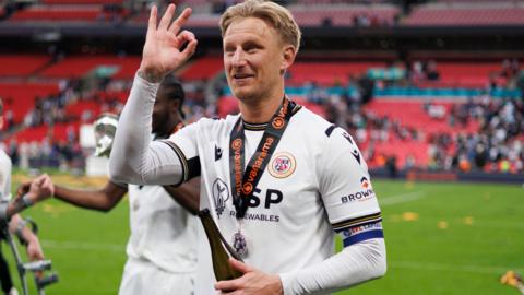 Byron Webster celebrates winning promotion with Bromley