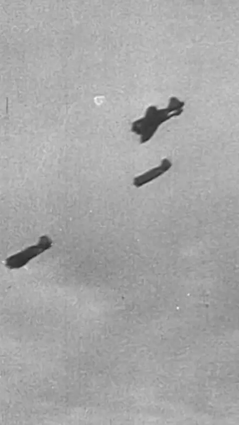 World War Two planes fly in a black and white image