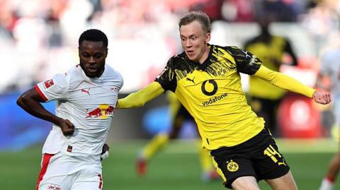 RB Leipzig's Ridle Baku and Borussia Dortumind's Maximilian Beier battle for possession