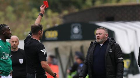 Wayne Rooney is shown the red card 