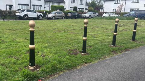 Black bollards around village green