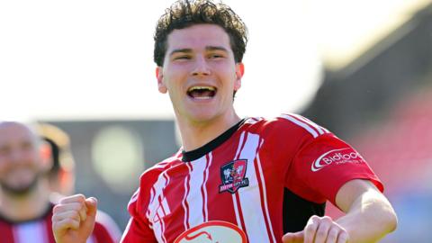 Ed James celebrating after Exeter beat Doncaster.