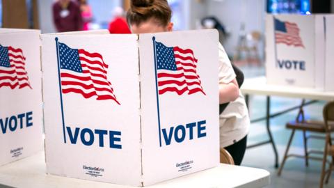 People cast their votes at the Whitman Middle School polling location in Alexandria, VA
