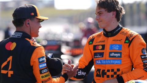 Oscar Piastri and McLaren team-mate Lando Norris clasp hands after Dutch Grand Prix qualifying