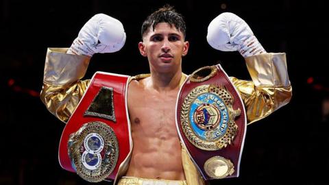 Royston Barney-Smith raises his arms with his WBO and IBF European belts after beating Danny Quartermaine