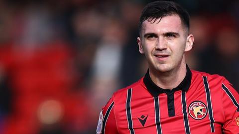 Oisin McEntee wearing a Walsall shirt