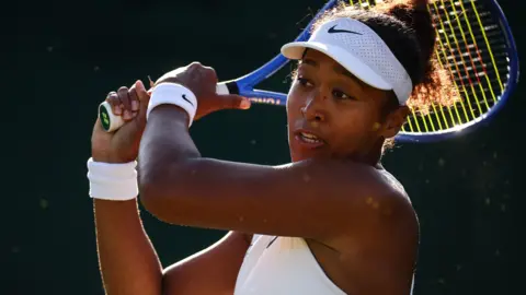 Naomi Osaka hits a backhand