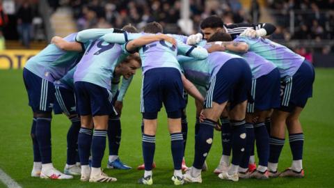 Arsenal players form a team huddle prior to the Premier League match against Fulham at Craven Cottage in December 2024