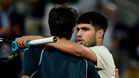 Carlos Alcaraz hugs Lorenzo Musetti