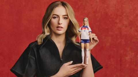Chloe Kelly poses with the Barbie doll of her likeness