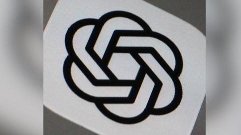 The ChatGPT logo. It looks like a number of chains all linked in a circle with each other.