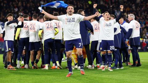 John McGinn of Scotland celebrates after the team's victory during the FIFA World Cup 2026 qualifier match between Scotland and Denmark.