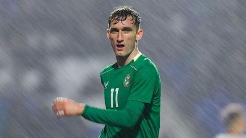 Mason Melia looking across the pitch in the rain for Ireland's Under-21s against England