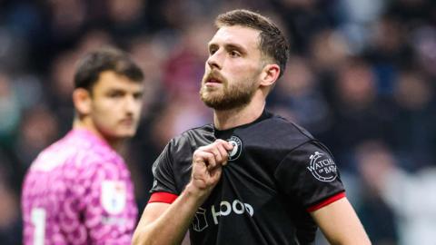 Joe Williams holds his Bristol City badge 