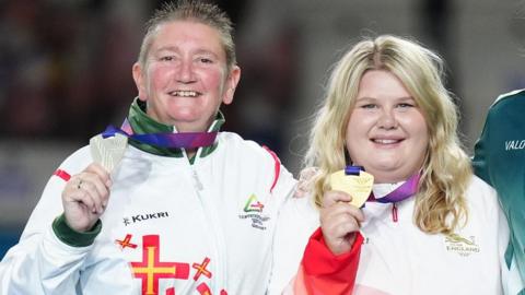 Katherine Rednall (right) holds her gold medal as Guernsey's Alison Merrien holds her silver medal