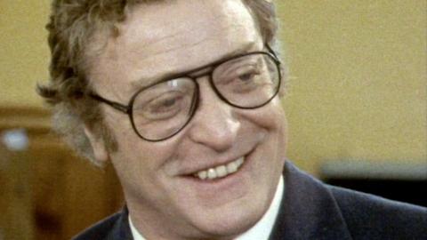 Michael Caine smiling during an interview in 1986