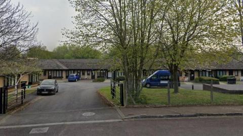 The Wheatridge care home in Abbeydale, a single-storey building fronted by trees and a car park