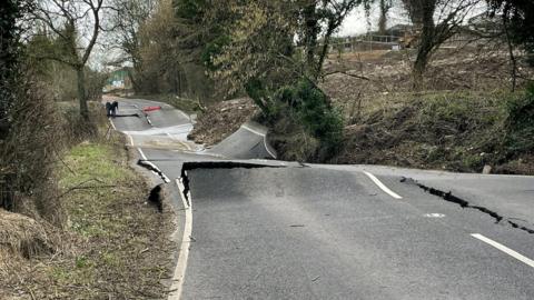 A wonky road with surface splits and rising parts