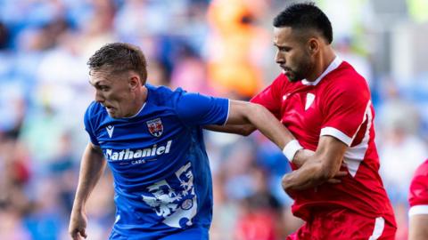 Nathan Wood holds off a defender for Penybont