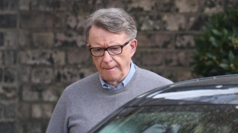 Former British ambassador to the US Peter Mandelson pictured getting into a vehicle 
