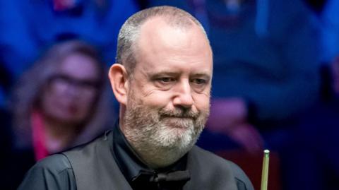 Mark Williams looks at the table