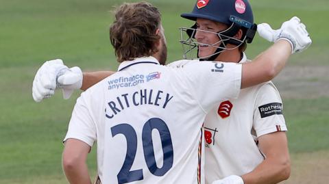 Matt Critchley and Jordan Cox hug