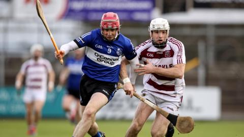 Slaughtneil's Paul McNeill battles with Sarsfields' Daniel Kearney in Newbridge