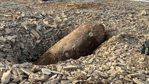 Bomb in amongst rubble at a building site