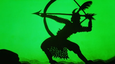 A silhouette of a person shooting an arrow against a green background
