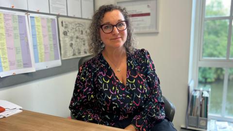 Nadine Peatfield sitting in an office