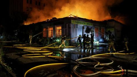 Firefighters work at a site hit by a Russian missile strike, amid Russia's attack on Ukraine, in Kyiv on 20 August.