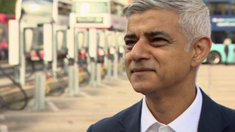 Sadiq Khan speaking to a reporter behind the camera