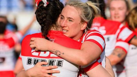 St Helens' Jodie Cunningham and Leah Burke hug in celebration at beating York Valkyrie