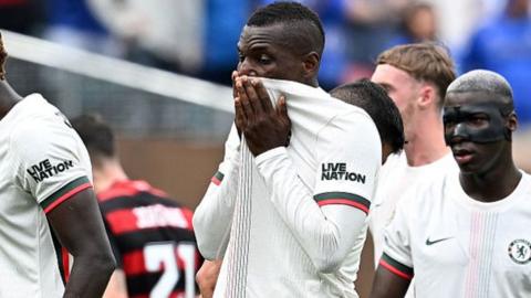 Nicolas Jackson covers his face with his shirt following his sending off