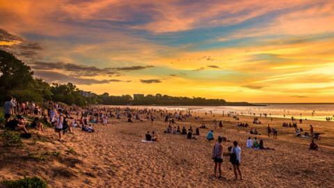 Wide image of an Australian beach at sunset.