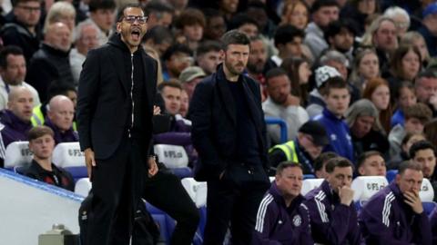 Liam Rosenior and Michael Carrick on the touchline during the Chelsea v Manchester United game earlier in April