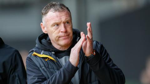 Graham Coughlan applauds fans while manager of Newport County