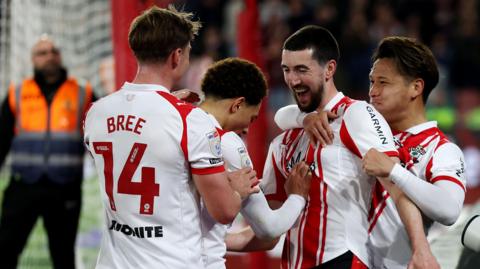 Finn Azaz celebrates with Southampton team mates