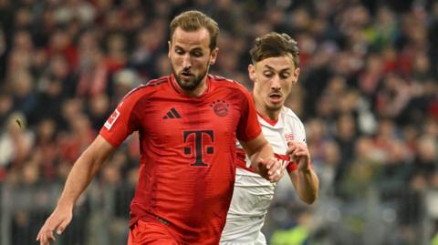 Harry Kane and Anthony Rouault vie for the ball