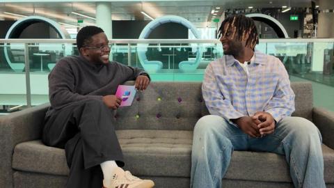 De-Graft talking to Myles Smith on a sofa