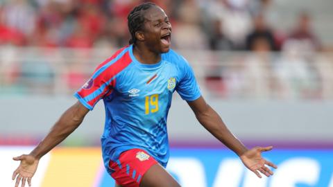 Merveille Kanjinga closes her eyes, spreads her arms and screams as she runs to celebrate a goal for DR Congo at the Women's Africa Cup of Nations in Morocco