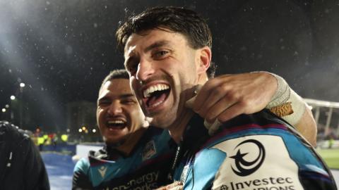 Sione Tuipulotu and Adam Hastings celebrate after Glasgow's win over Toulouse