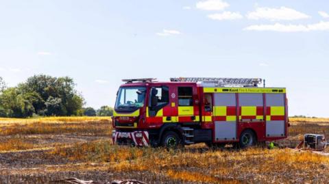 A fire engine in a burnt out field (stock image)