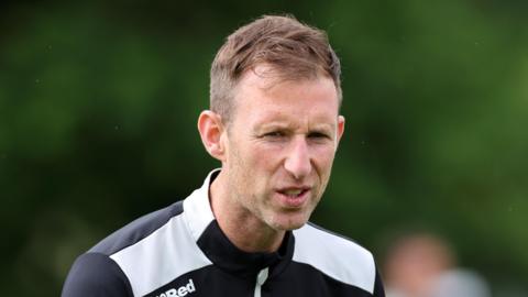 Mike Williamson shouting an instruction during a training session